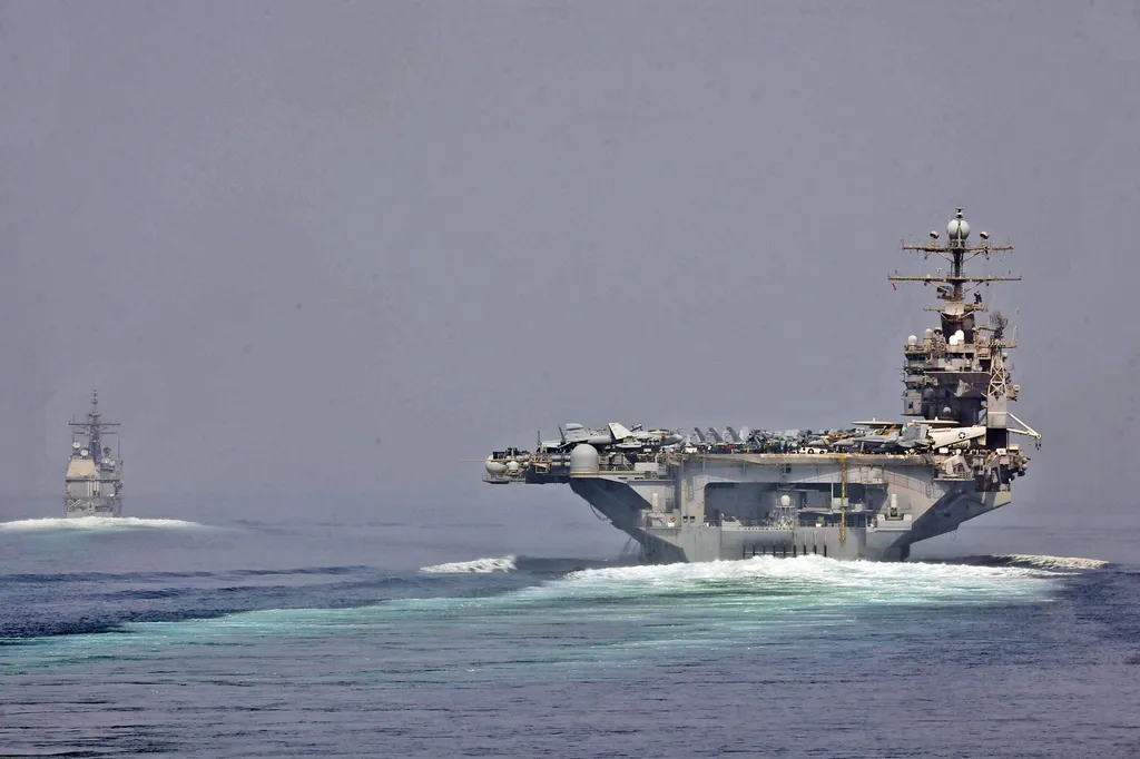 US Navy vessels transiting the Strait of Hormuz in an archive photograph; not an image of the reported incidents