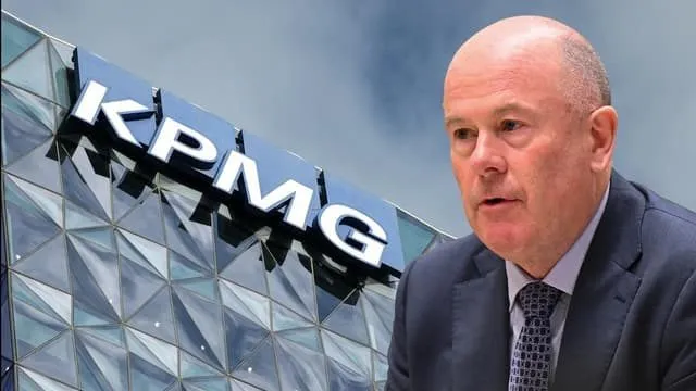 KPMG logo on a glass office building beside a company executive