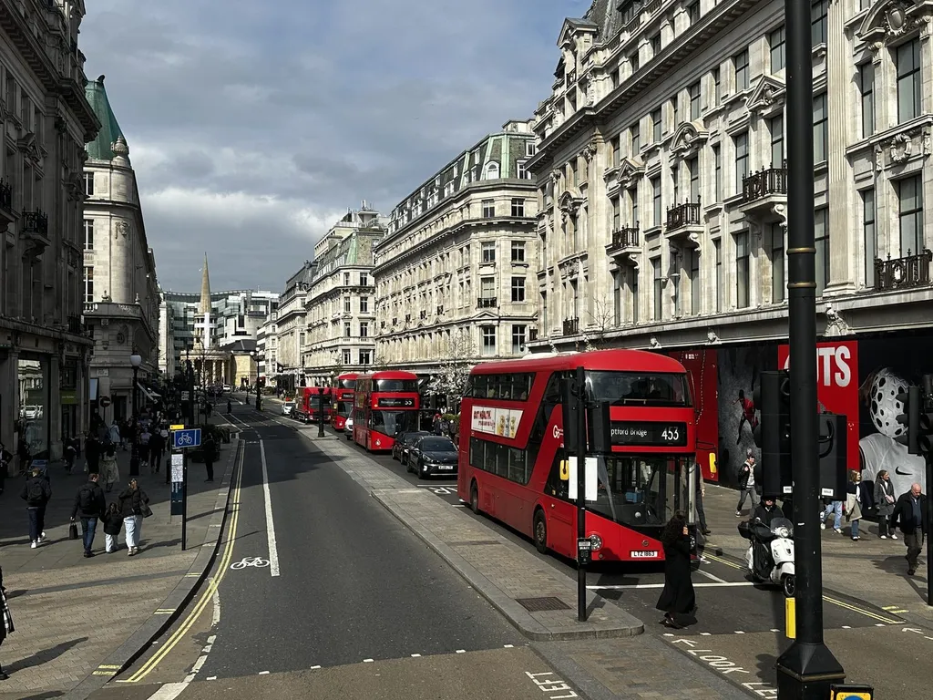 Shoppers and red double-decker buses on Regent Street, London