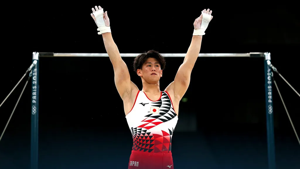 Daiki Hashimoto of Japan raises his arms at the horizontal bar during the Paris 2024 Olympics
