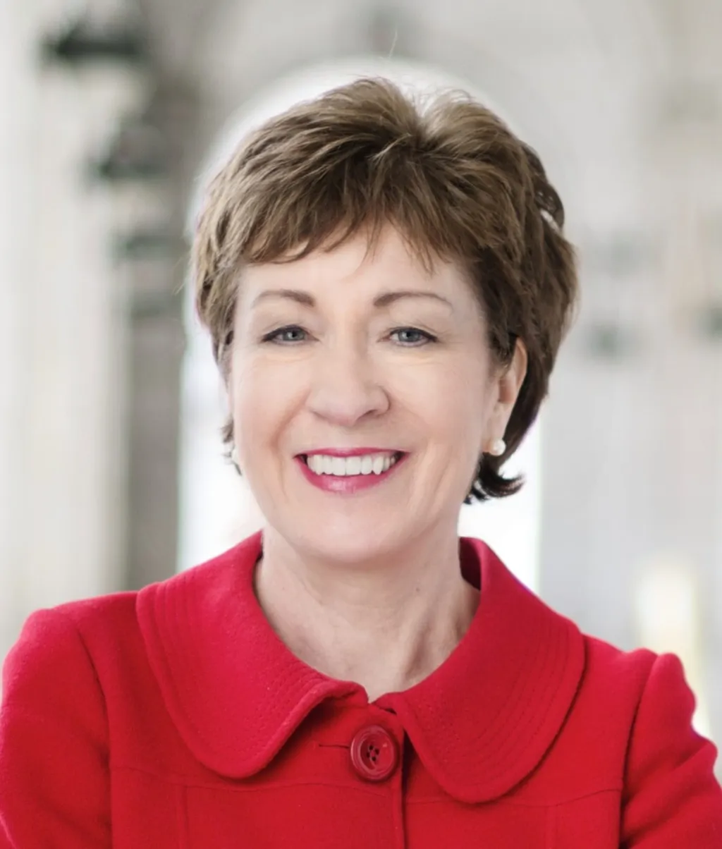 Official 2014 US Senate portrait of Senator Susan Collins of Maine, smiling in a red jacket