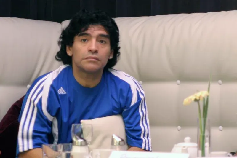Diego Maradona seated at a table in Leipzig, Germany, during the 2006 FIFA World Cup.