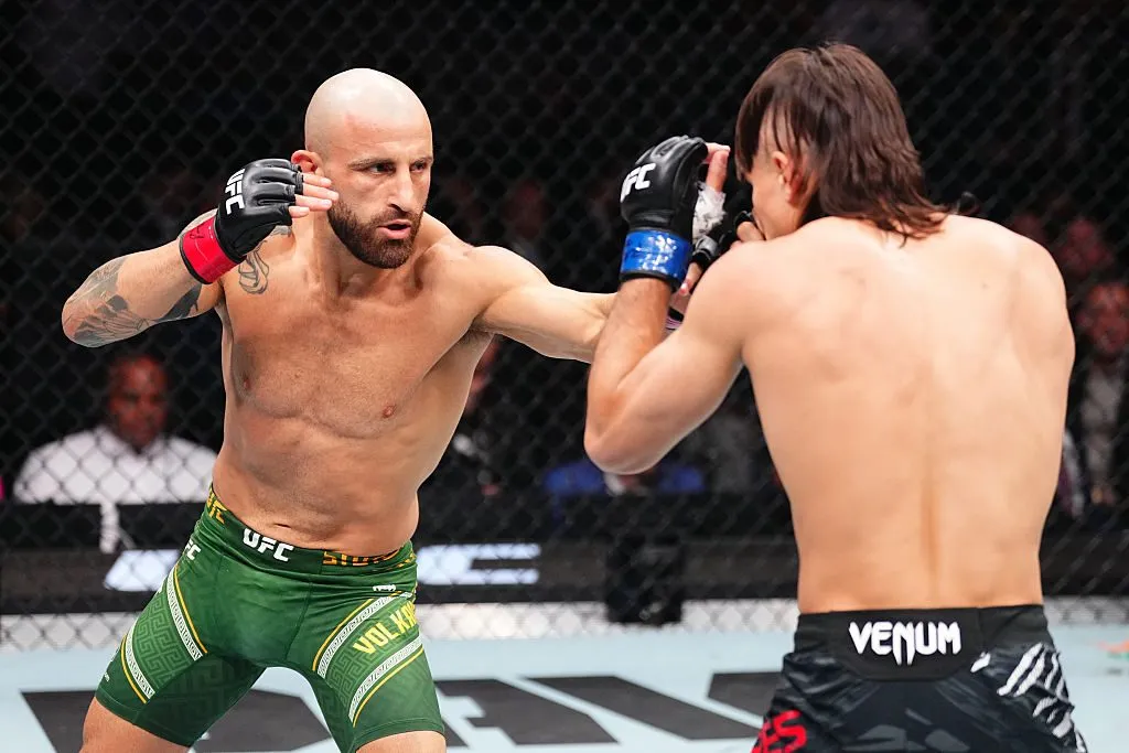 Alexander Volkanovski exchanges punches with Movsar Evloev in the UFC octagon
