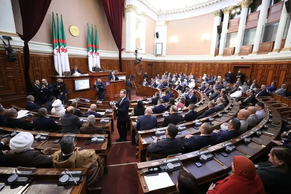 Members seated in the Algerian upper house chamber beneath Algerian flags