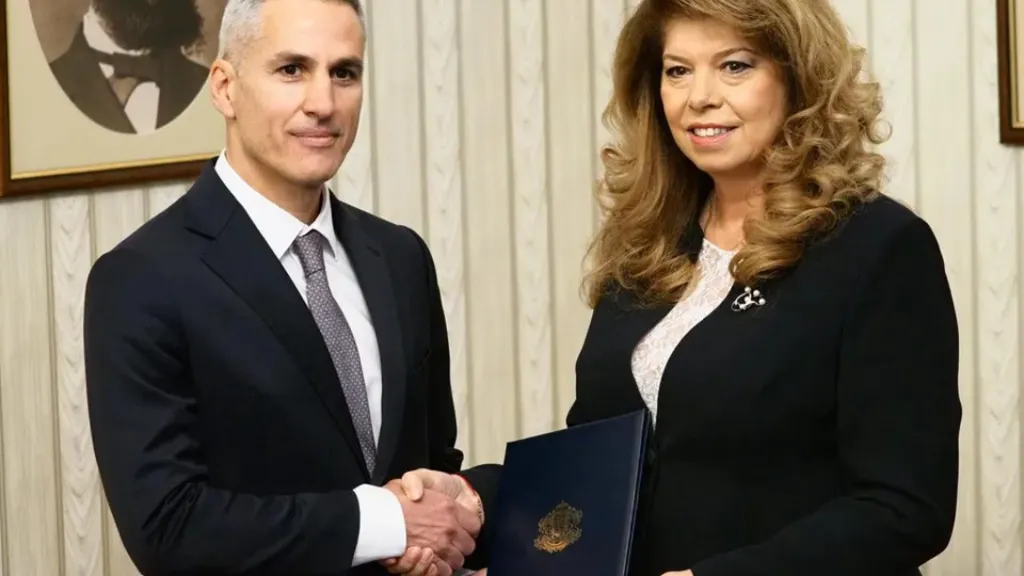 Andrey Gyurov and Iliana Iotova shake hands as Gyurov presents his cabinet to Iotova