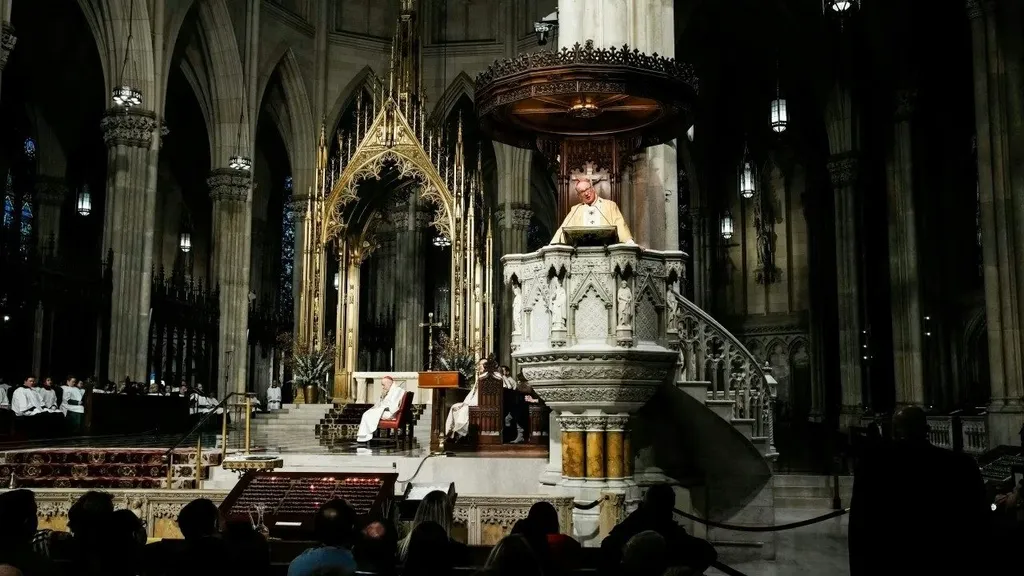 A priest speaks from the pulpit inside St Patrick's Cathedral in New York