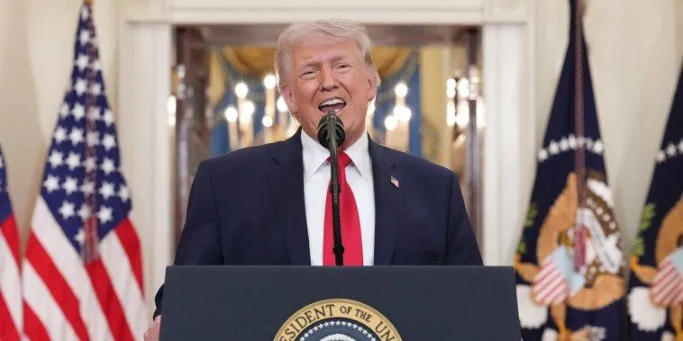 Donald Trump speaking at a presidential podium in the White House