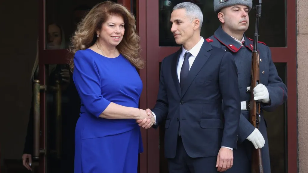Iliana Iotova and Andrey Gyurov shake hands at an official event in Bulgaria