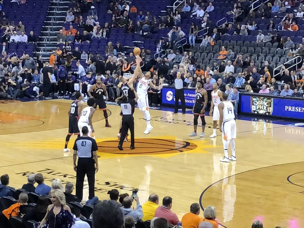 NBA game action as a Phoenix Suns player shoots against the Toronto Raptors in Phoenix