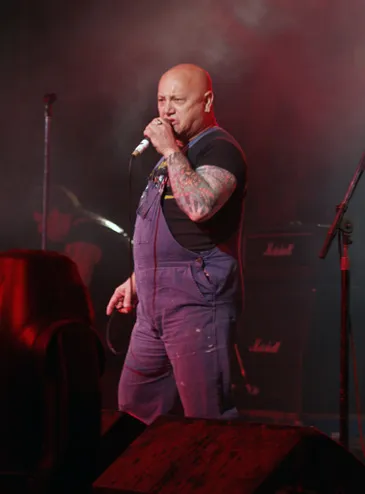 Gary 'Angry' Anderson performing on stage with Rose Tattoo