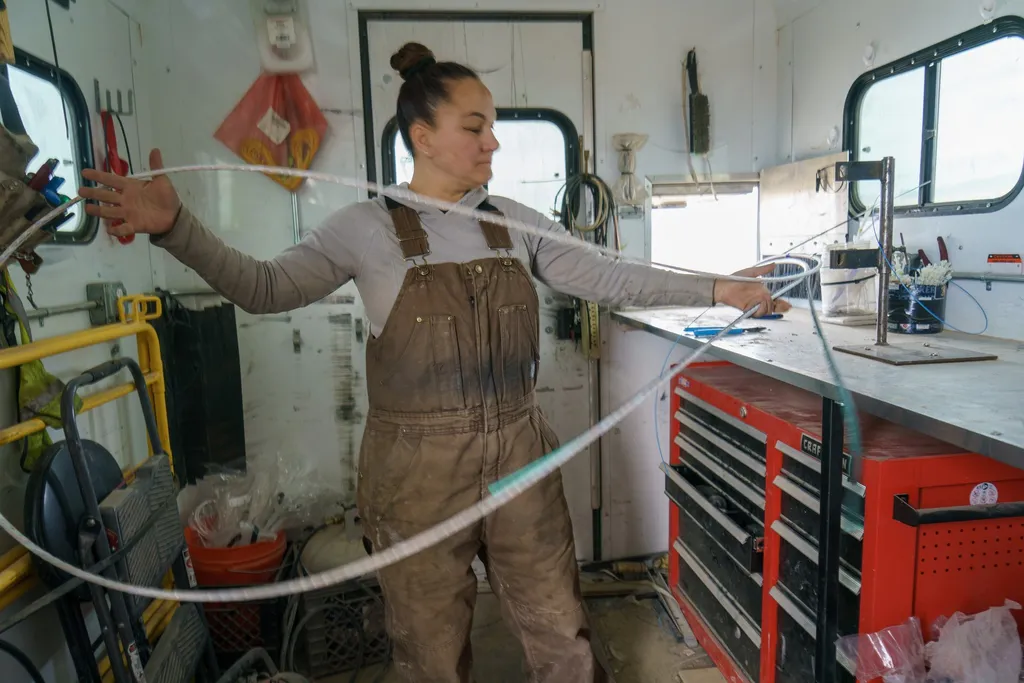 A field crew member handling fibre-optic cable during a USDA Rural Development rural broadband installation in Utah, February 2024.
