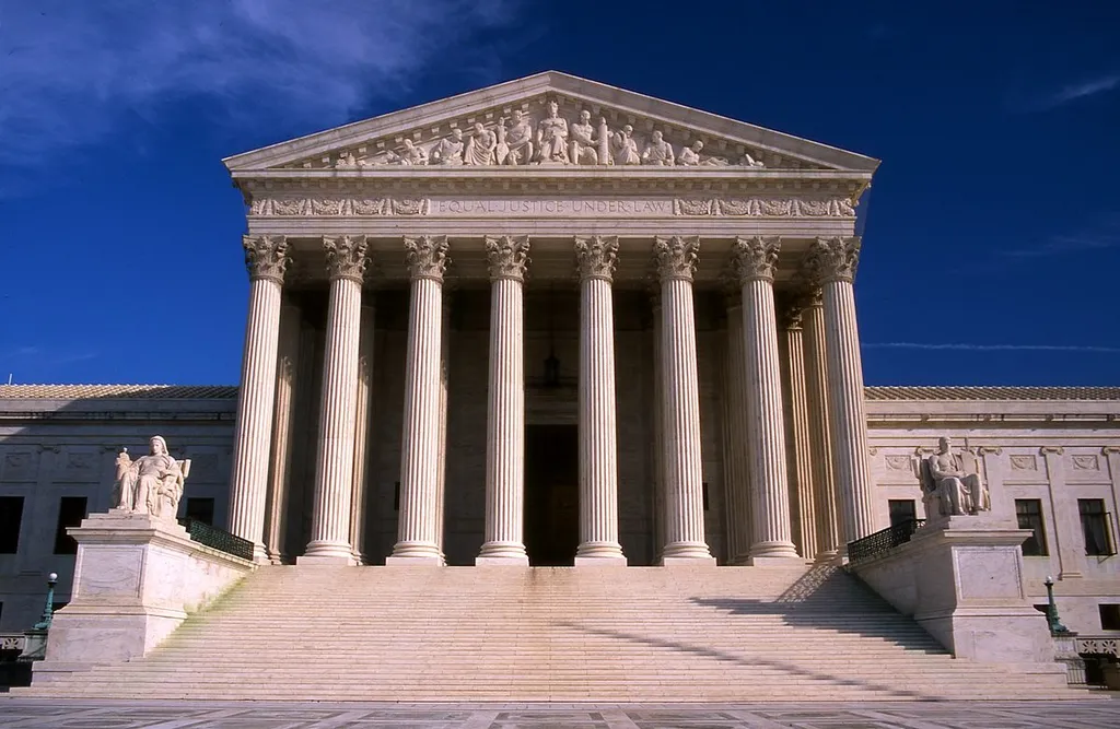 The west facade of the US Supreme Court building in Washington, DC, showing its Corinthian columns, pediment sculptures and the 'Equal Justice Under Law' inscription.