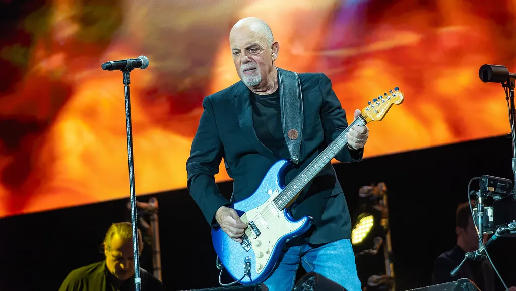 Billy Joel performing on guitar on stage at BST Hyde Park in London, July 2023.