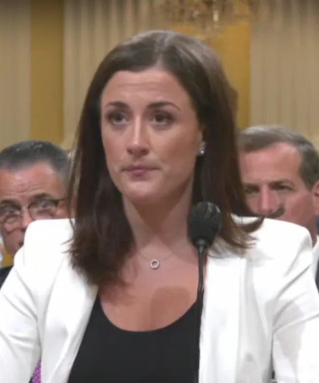 Cassidy Hutchinson testifying at a House Select Committee hearing on the January 6 attack, wearing a white blazer.
