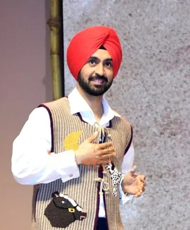 Diljit Dosanjh wearing a red turban at the Amar Singh Chamkila trailer launch in Mumbai, 2024.