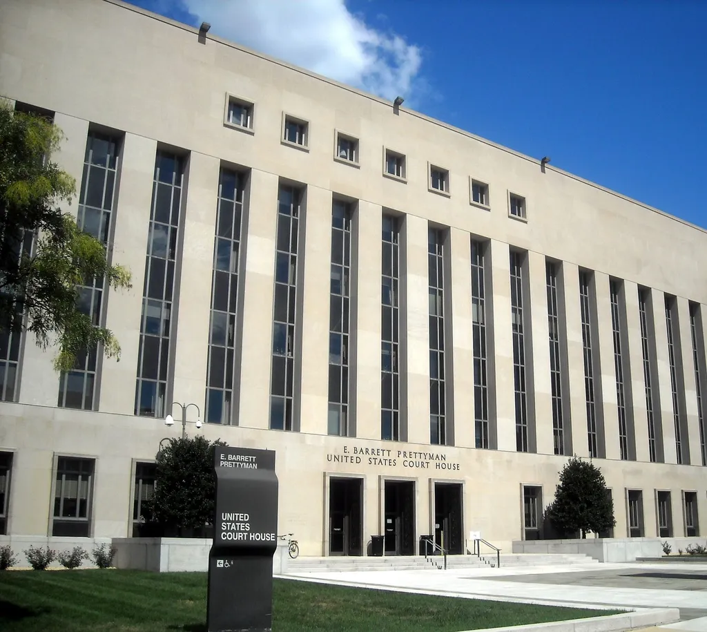 The E. Barrett Prettyman United States Courthouse in Washington, DC, a large limestone federal courthouse with tall vertical windows and an entrance sign, home of the U.S. District Court for the District of Columbia where the DNC filed its lawsuit.