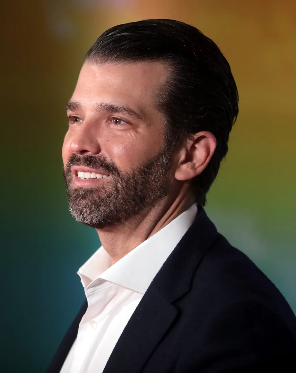 Donald Trump Jr. speaking at a microphone
