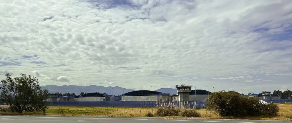 Guard towers and cell blocks of the Latacunga penitentiary in Ecuador, with Andean mountains behind