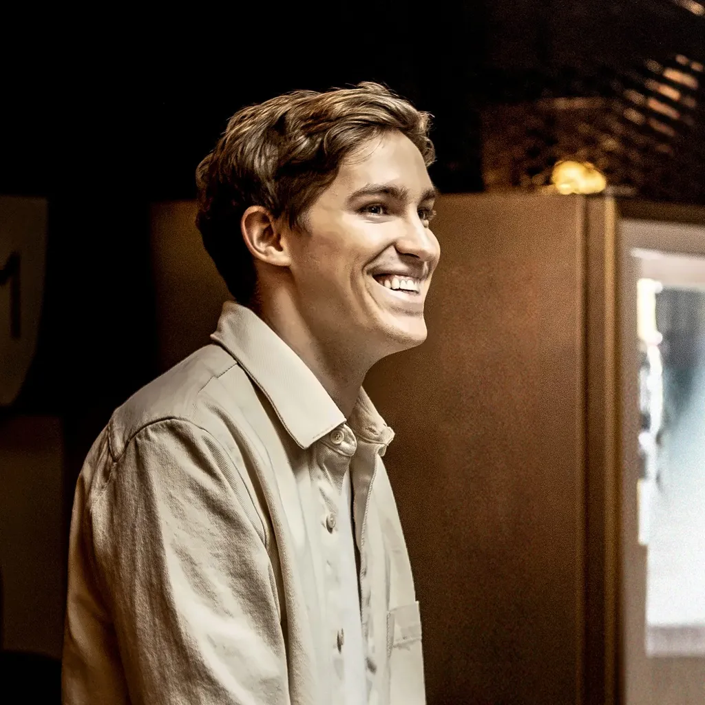 ElevenLabs co-founder and chief executive Mati Staniszewski, smiling in a light-coloured shirt, in a 2022 portrait.