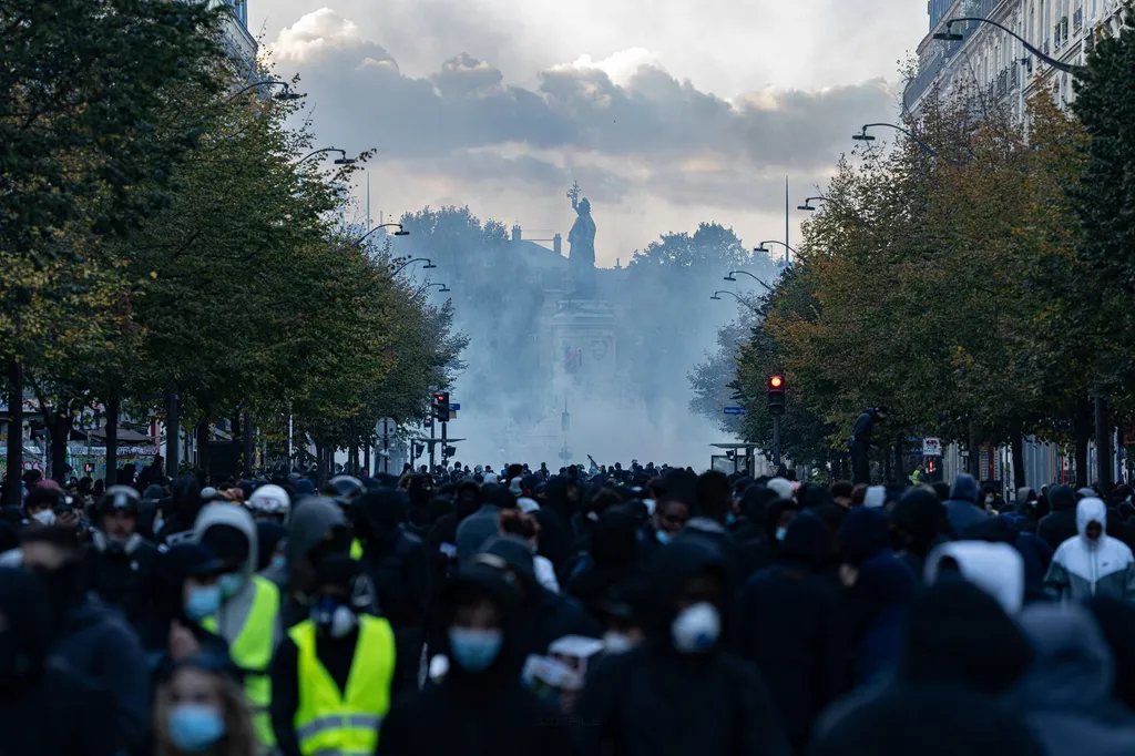 Crowd of demonstrators facing Place de la Republique in Paris amid tear gas during the 17 October 2026 cost-of-living protests