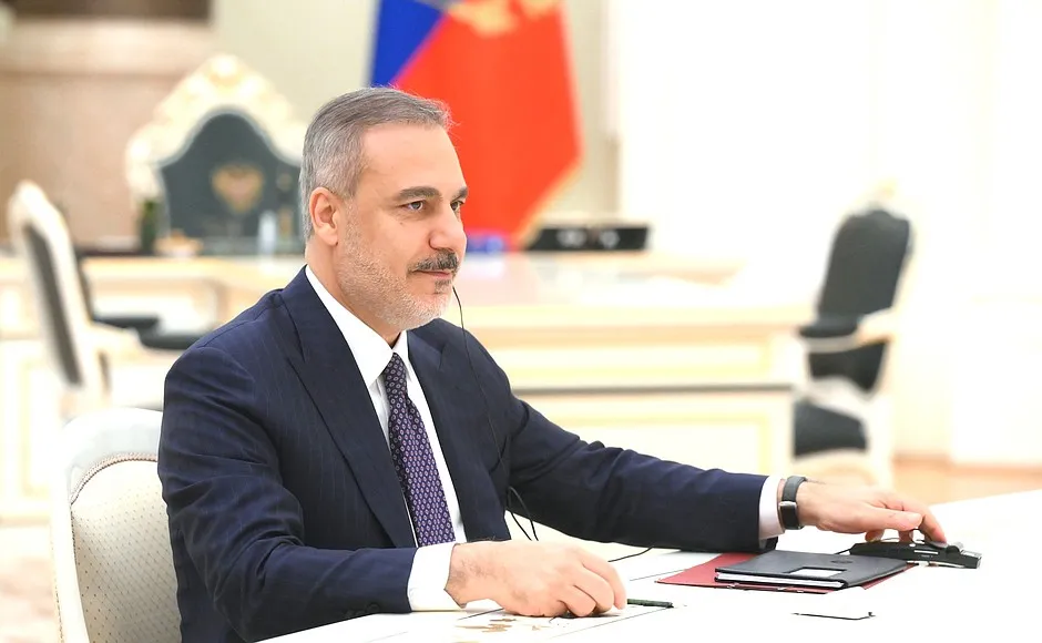 Turkish Foreign Minister Hakan Fidan seated at a meeting table