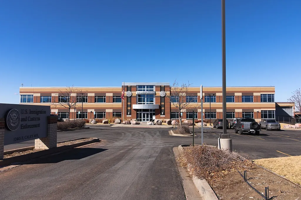 The Jim Bailey Building in Centennial, Colorado, home of the ICE Denver Field Office, with the U.S. Immigration and Customs Enforcement sign and seal at its entrance.
