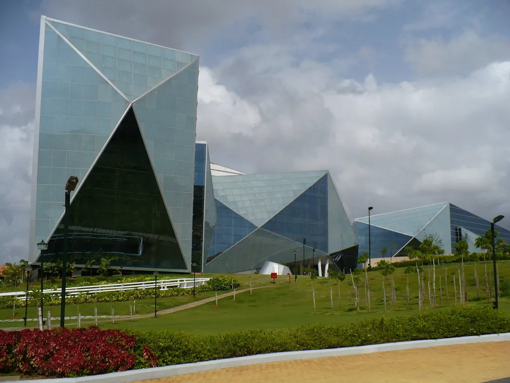 Glass pyramid-style buildings of the Infosys campus in Mysore, India, set behind lawns and landscaped gardens