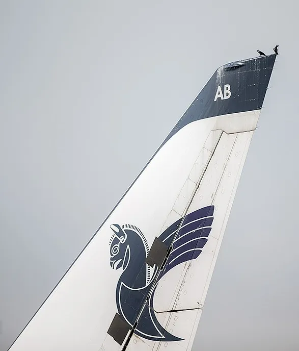 Tail fin of an Iran Air Airbus A330-200 showing the airline's blue emblem, photographed at Mehrabad International Airport in Tehran.