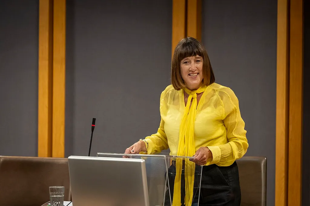 Jane Dodds MS speaking at a lectern in the Senedd chamber