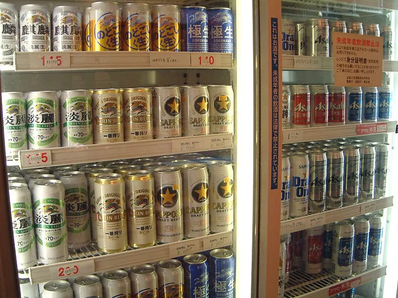 Refrigerated shelves in a Japanese liquor shop stocked with cans of Sapporo Draft Beer, Kirin Beer and Asahi beer