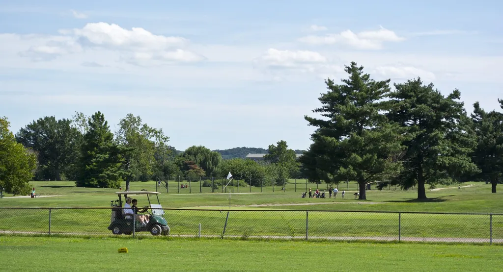 Golfers and a golf cart on the Blue and Red courses at East Potomac Golf Links in Washington DC