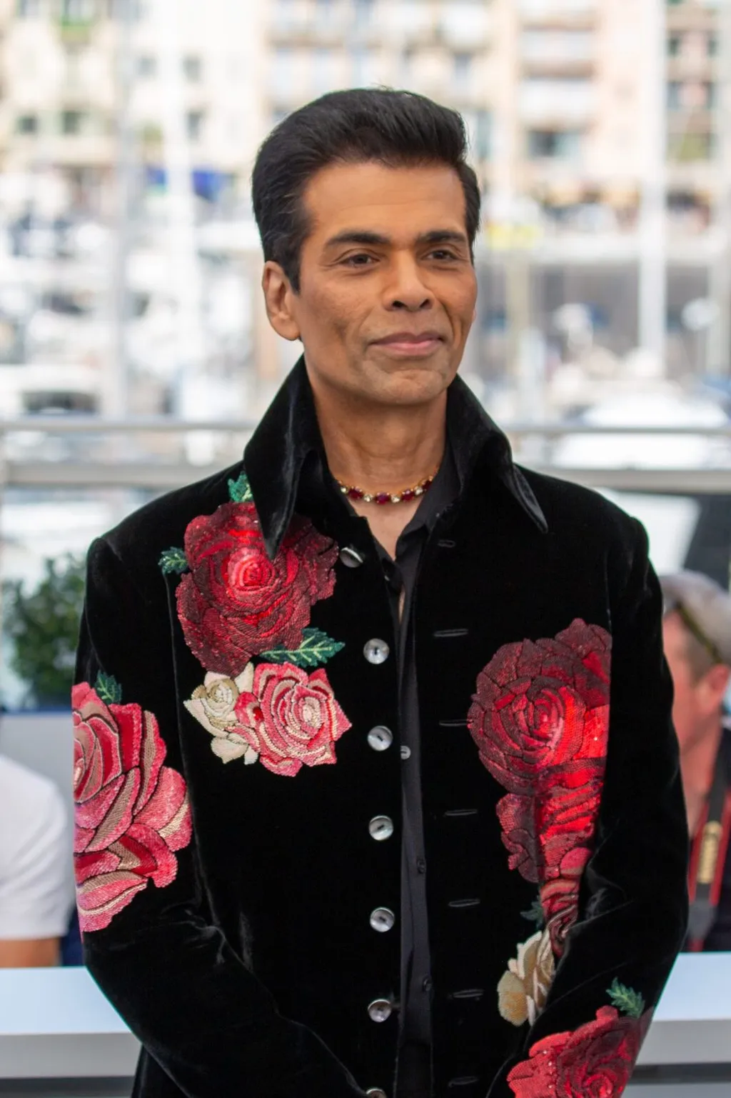 Karan Johar at the Homebound photocall during the 2025 Cannes Film Festival, wearing a black velvet jacket with floral embroidery