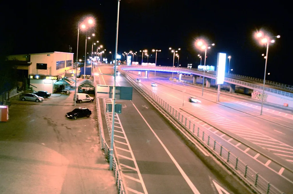 A Kyiv road lit by streetlights at night