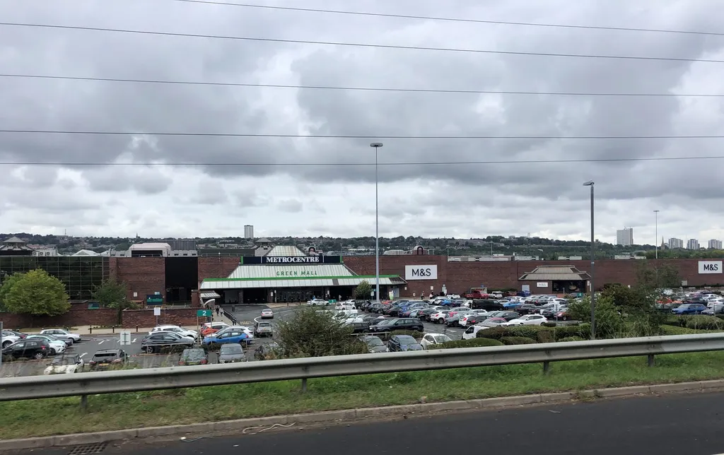 The Metrocentre shopping centre in Gateshead, with its Green Mall entrance and an M&S storefront beside a busy car park