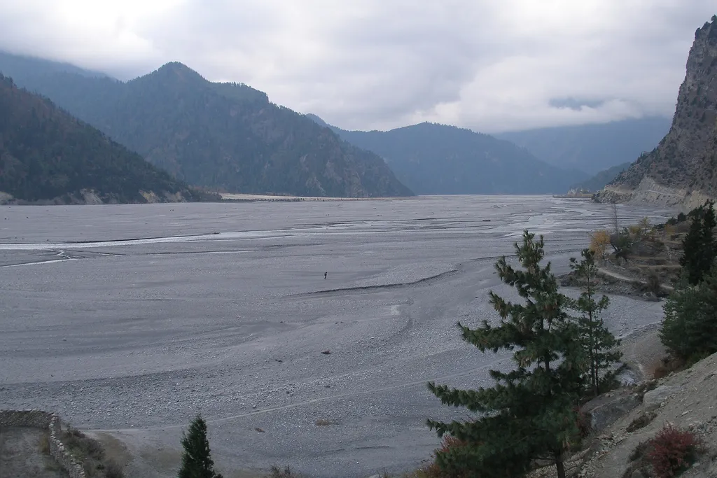 The wide braided riverbed of the Kali Gandaki Valley in the Nepal Himalayas.