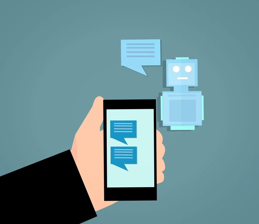 Illustration: a hand holds a smartphone with chat bubbles beside a generic robot assistant, representing an AI chatbot (illustrative image)