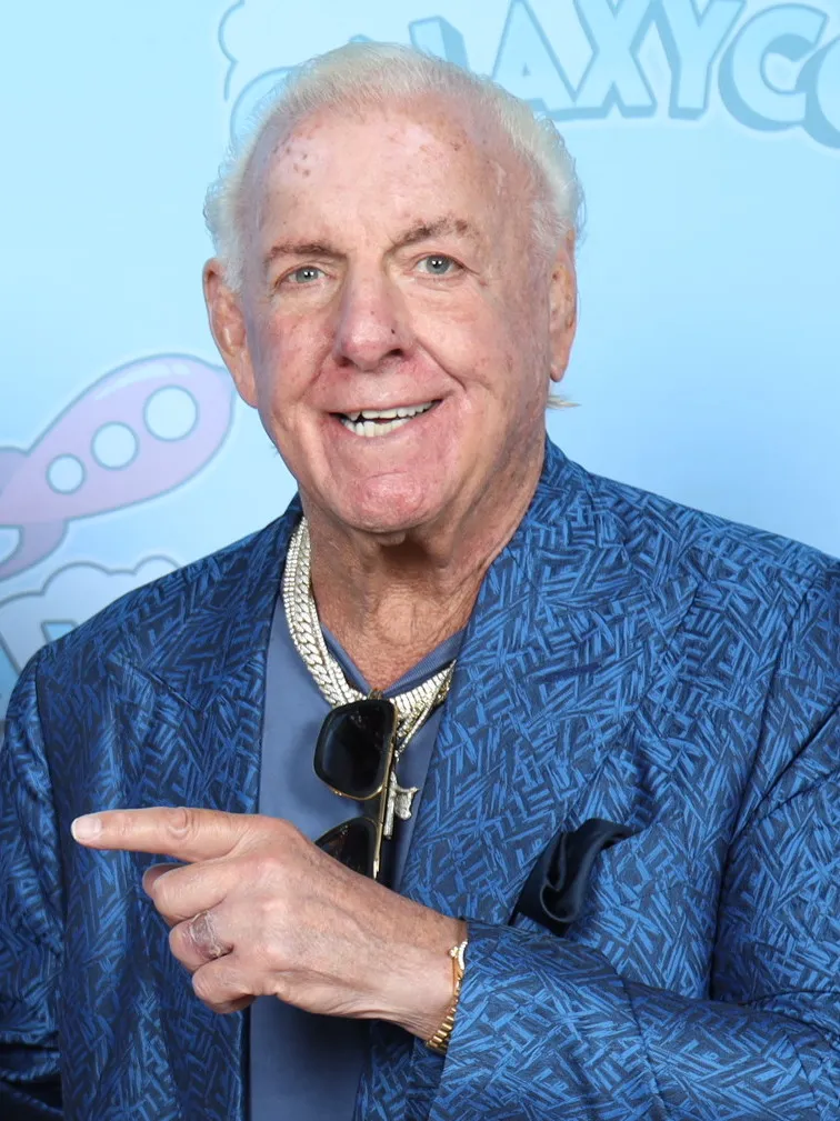 Ric Flair pointing towards the camera at a GalaxyCon Austin photo op, 2023.