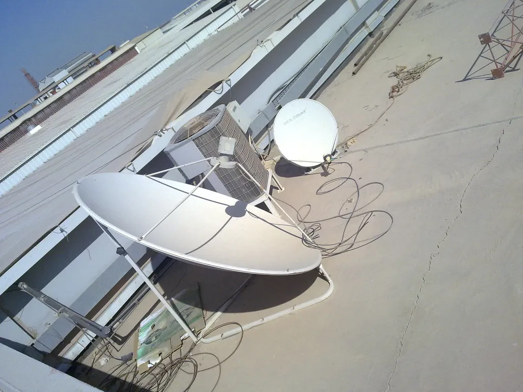 Two satellite dishes installed on a rooftop