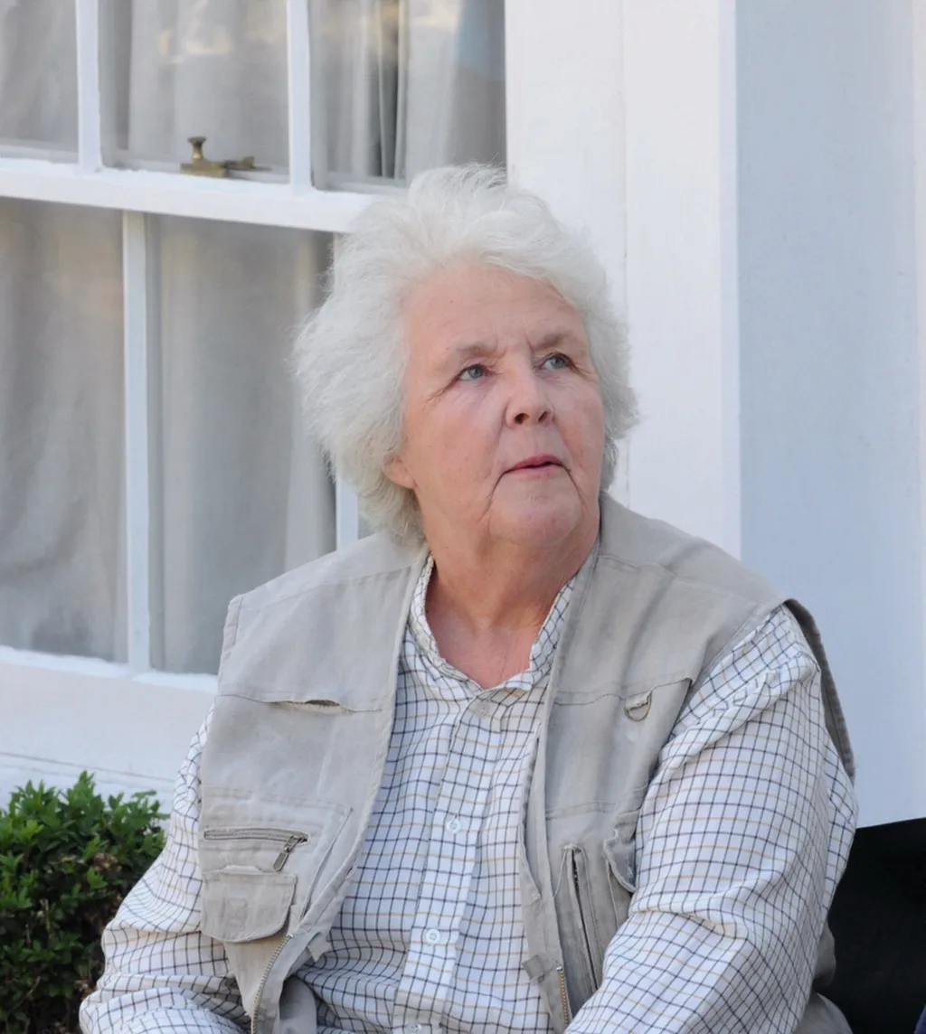 Stephanie Cole seated outdoors on the Doc Martin set in Port Isaac, Cornwall, during filming of Series 4 in 2009.