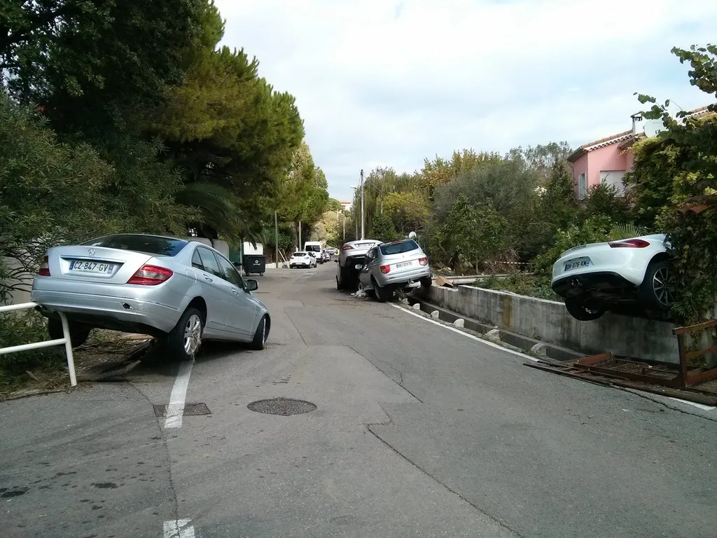 Cars displaced and piled up on a street in the Alpes-Maritimes, southern France, after flash flooding