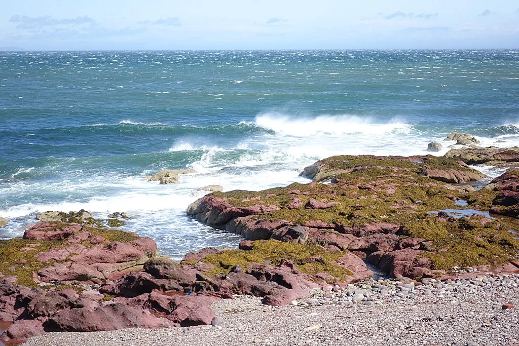 Storm waves breaking against a rocky Scottish coastline — illustrating the severe coastal conditions forecast as Storm Boelo approaches