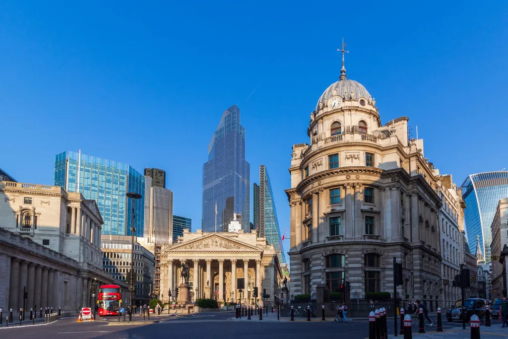 The Royal Exchange and Bank of England area in the City of London, with a red double-decker bus and modern City skyscrapers behind