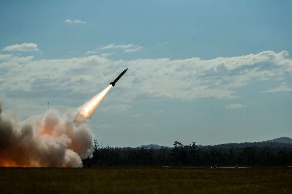 A MIM-104 Patriot interceptor missile launching skyward in a blaze of flame and smoke during a US military exercise