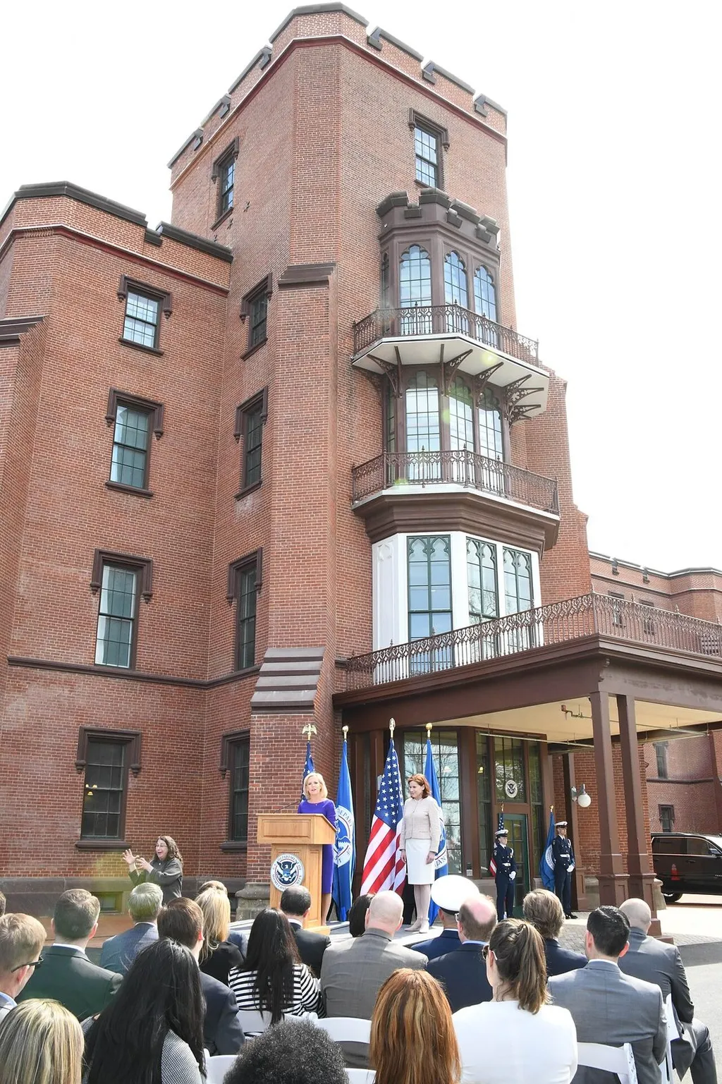 DHS headquarters Building 1 on the St. Elizabeth’s Campus in Washington, DC, with DHS and US flags and the DHS seal on the podium during the headquarters opening ceremony