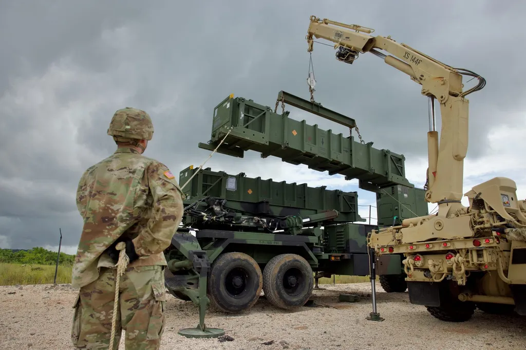 U.S. Army soldier watching a crane lift a PAC-2 missile canister onto a MIM-104 Patriot launcher during exercise Tenacious Archer 25 in Palau