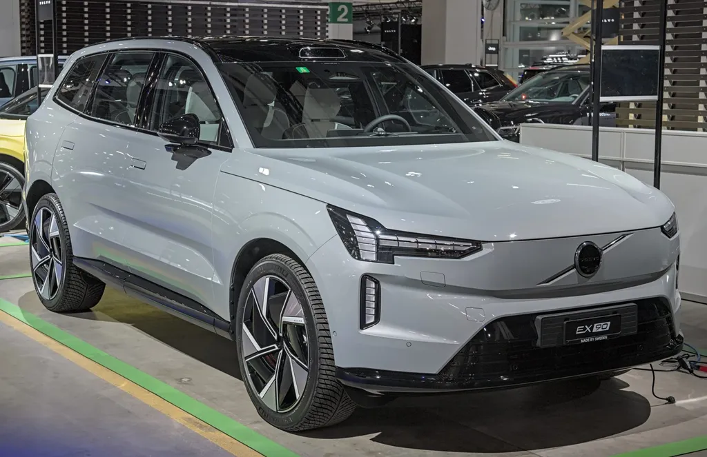 A dark Volvo EX90 electric SUV on display at the Auto Zürich 2024 motor show.