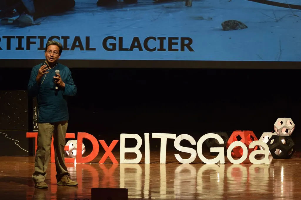 Climate activist Sonam Wangchuk speaking into a microphone at a public event in 2017.