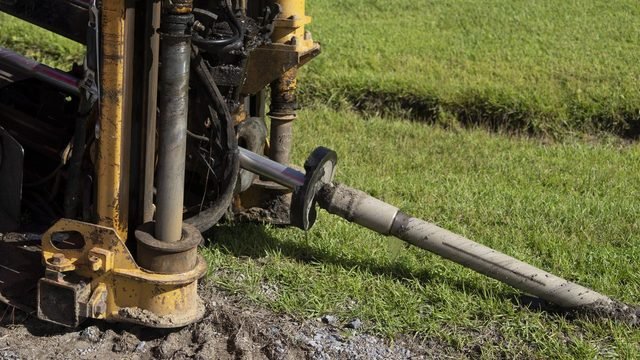 A directional drilling rig inserts underground conduit for fibre-optic cable in a rural field in Berkeley County, South Carolina, during a USDA ReConnect broadband project.